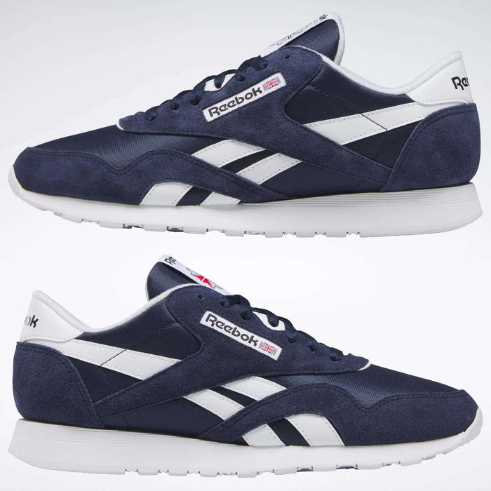 A pair of Men's Classic Nylon Shoes by Reebok in navy blue with white accents, white soles, and the Reebok logo featuring a small British flag on the sides and tongue, shown on a plain white background.
