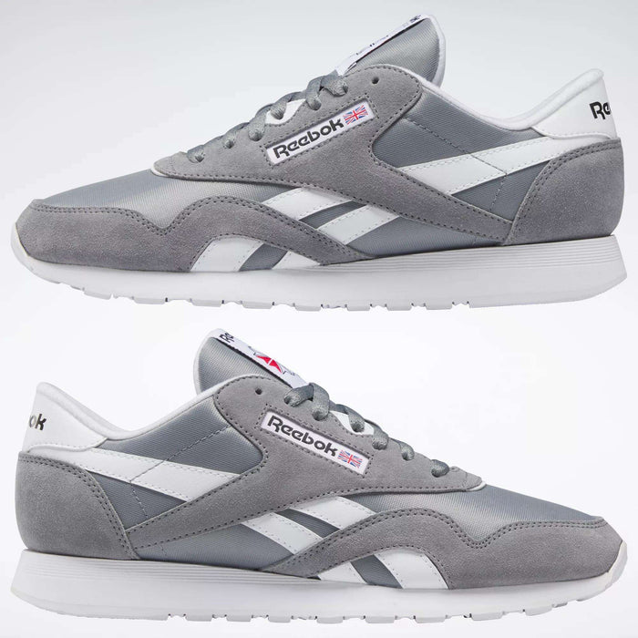 The Reebok Men's Classic Nylon Shoes are shown in gray and white from both sides on a plain white background, featuring a durable nylon upper, white laces, a white sole, and the iconic Reebok logo with a small British flag.