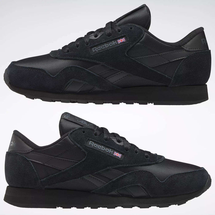 A pair of black Reebok Men's Classic Nylon Shoes with suede, mesh, and nylon upper details, classic branding, and a Union Jack flag on the side—shown in left view on a plain background. Perfect for everyday wear.