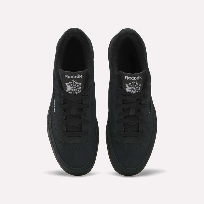 Top view of Reebok Club C 85 Shoes in black with a suede upper, black laces, and soles. The white Reebok logo is visible on the tongue, set against a plain light background.