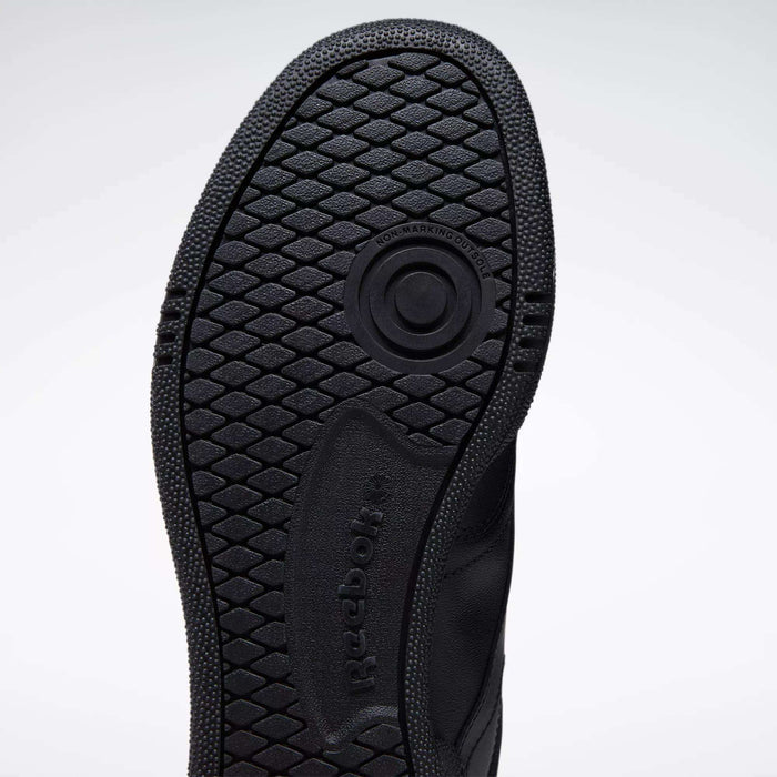 Close-up of the black rubber sole on the Reebok Club C 85 Shoes, featuring a textured hexagonal tread and circular groove, with visible Reebok branding—highlighting its tennis-inspired design.