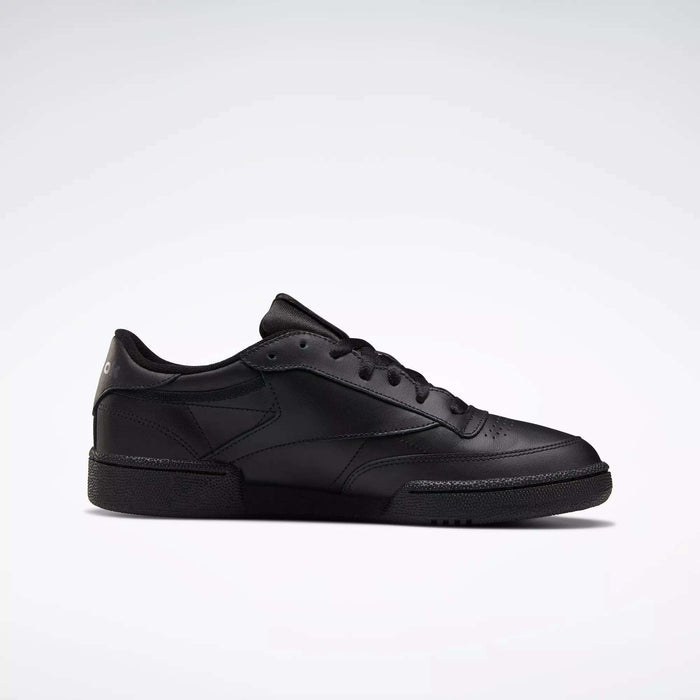 The Reebok Club C 85 Shoes are black low-top leather sneakers with black laces and a textured rubber sole, inspired by the classic design, shown on a plain white background.