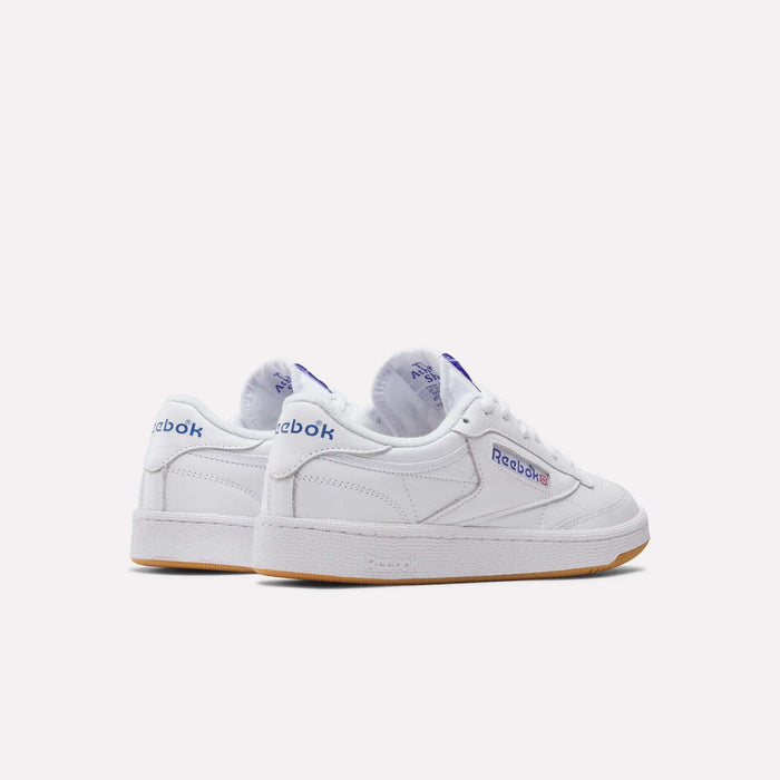 A pair of Reebok Club C 85 Shoes in white leather with blue and red logo details, gum rubber soles, and clean stitching, displayed on a plain white background.