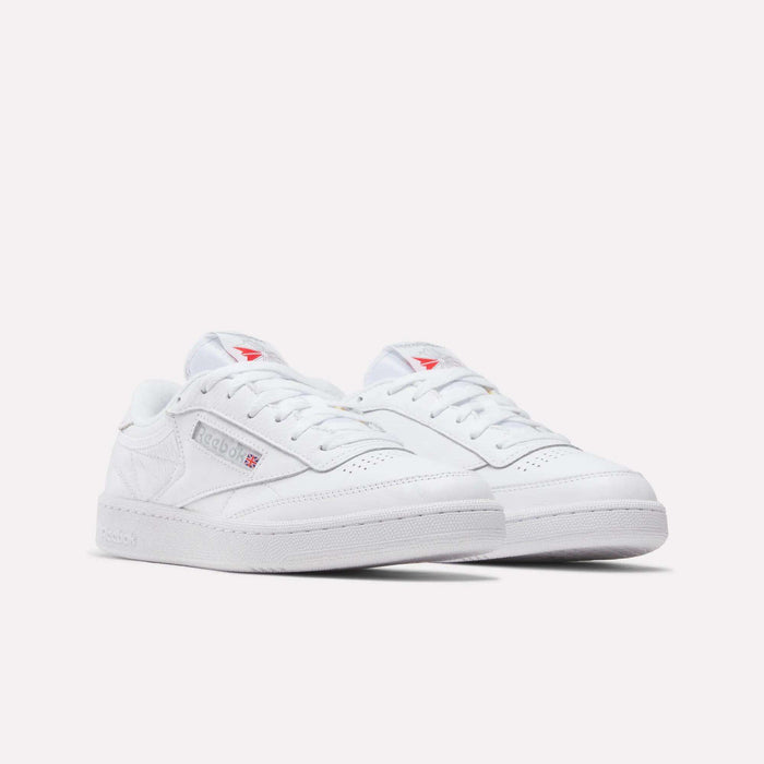 A pair of Reebok Club C 85 Shoes in classic white leather with low tops, subtle branding, and red logo accents, shown on a plain white background.