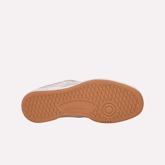 A bottom view of the Club C 85 Vintage LTD Shoes by Reebok in beige and brown, showcasing the textured rubber sole with the Reebok logo and signature circular tread pattern—an iconic detail of this lifestyle classic.