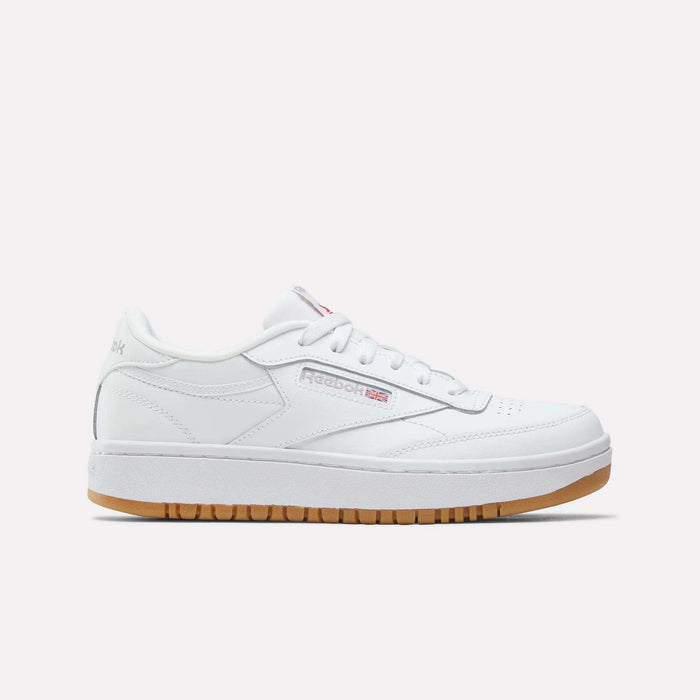 The Reebok Club C Double Shoes - Big Kids feature a white leather upper, low-top design, white laces, subtle Reebok branding, and a light brown gum sole, shown against a plain white background.