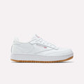 The Reebok Club C Double Shoes - Big Kids feature a white leather upper, low-top design, white laces, subtle Reebok branding, and a light brown gum sole, shown against a plain white background.