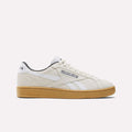The Reebok Club C Grounds UK Shoes in beige premium suede feature white stripes and logo, white laces, and a gum-colored sole for a classic look—all set against a plain white background.