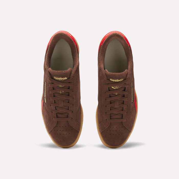 The Reebok Club C Grounds UK Shoes feature a brown suede upper, gold lettering, and red accents—archive-inspired sneakers that showcase classic Reebok heritage, shown from above on a plain white background.