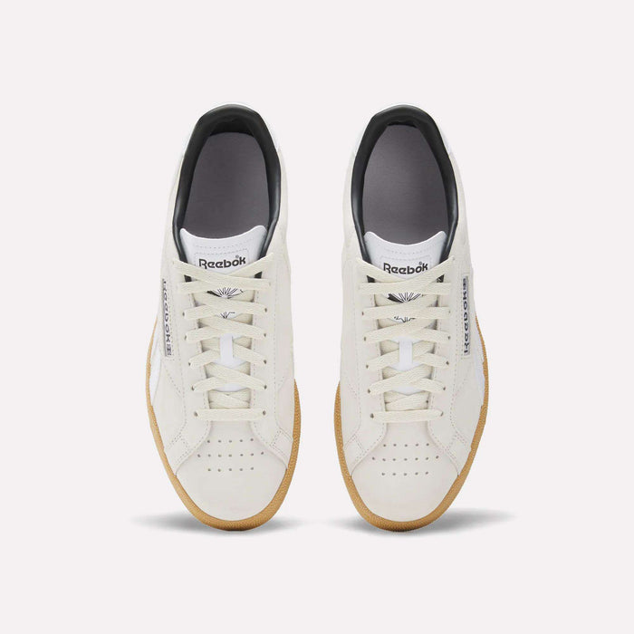 A top view of the Reebok Club C Grounds UK Shoes in white with beige soles. These sneakers feature white laces, perforated toe boxes, and the Reebok logo on both tongue and side for a classic look.