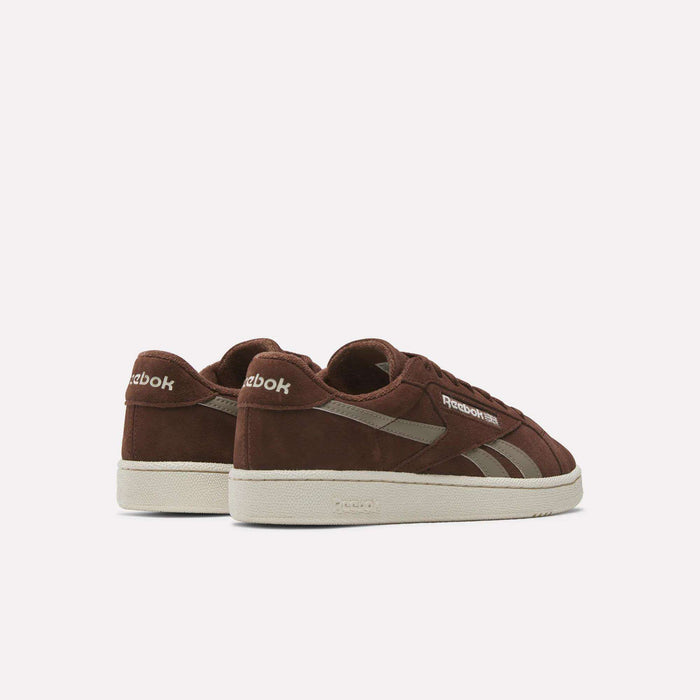 The Reebok Club C Grounds UK Shoes feature a brown suede upper, beige soles, and beige Reebok logos, displayed from the back and side on a plain white background.