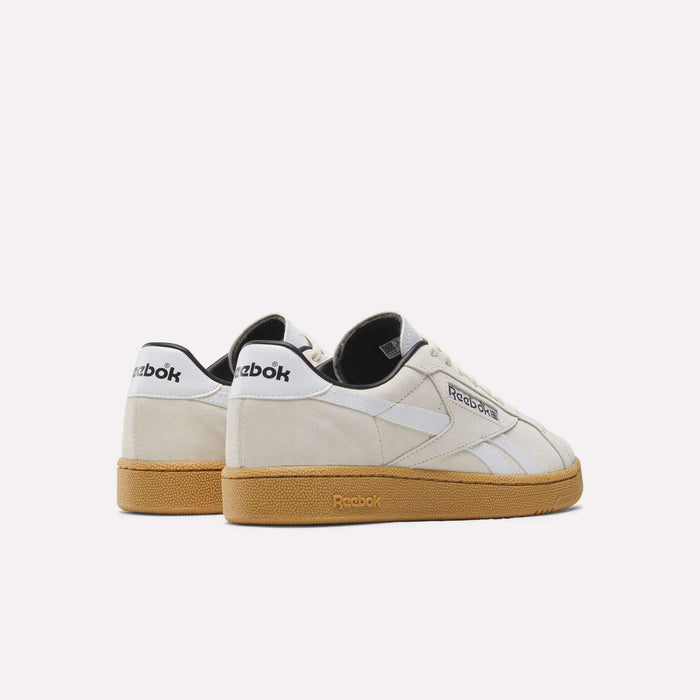 The Reebok Club C Grounds UK Shoes feature a premium off-white suede upper, white side stripes, black heel accents, and gum-colored soles, displayed against a plain white background.
