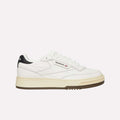 A white Reebok sneaker with a beige sole, black heel detail, and Reebok logo on the side, shown in a side profile on a plain white background.