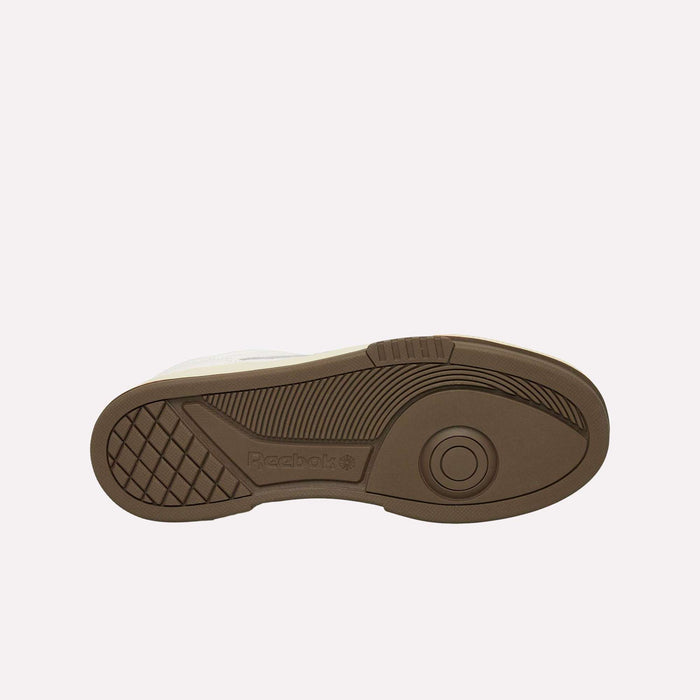 The brown rubber sole of the Reebok Club C LTD Shoes is displayed against a white background, highlighting its textured grip patterns and the iconic Reebok logo—a true lifestyle classic.