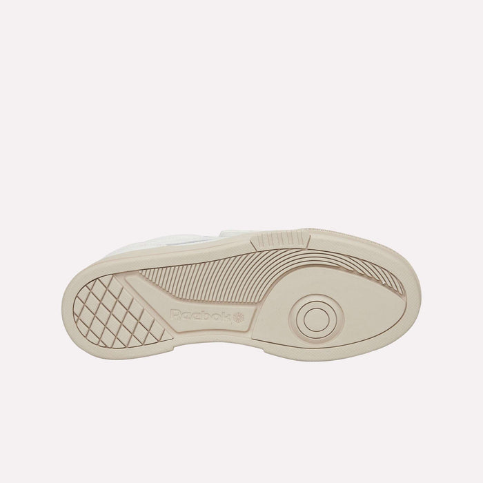 The image displays the beige sole of a Reebok Club C LTD shoe, featuring textured grip patterns, a circular design near the toe, and the Reebok logo embossed in the arch area—an enduring lifestyle classic.