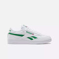 The Reebok Club C Revenge Shoes feature a classic white leather low-top design with green logo and side stripes, set against a plain white background. These casual trainers offer a timeless silhouette and durable rubber sole for everyday wear.