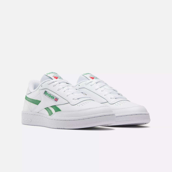 A pair of Reebok Club C Revenge Shoes in white with green accents and the Reebok logo and flag on the side, shown against a plain white background.