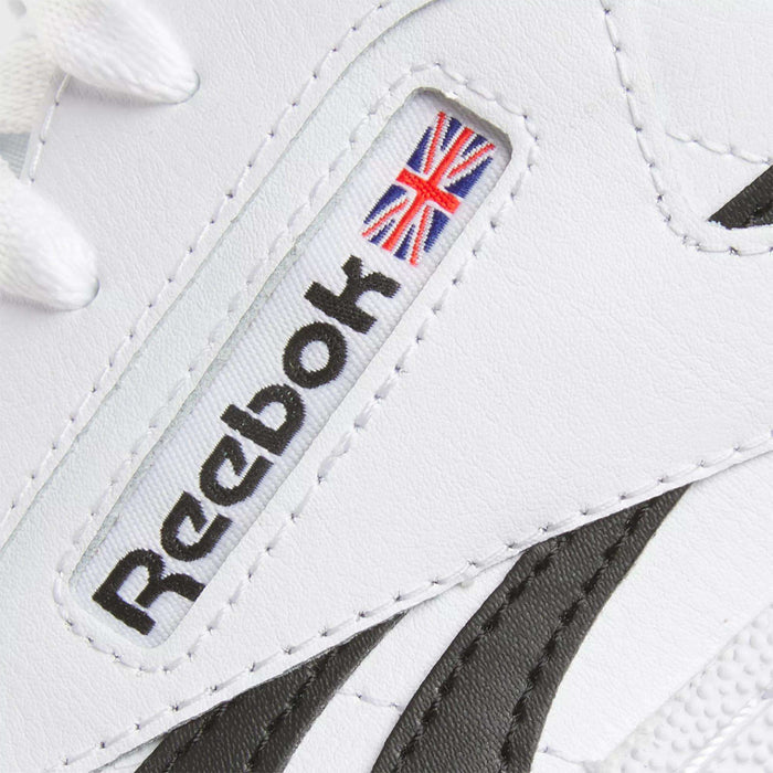 Close-up of the Reebok Club C Revenge Shoes in white, featuring the black Reebok logo and a small Union Jack flag on the side, with contrasting black and white design accents.