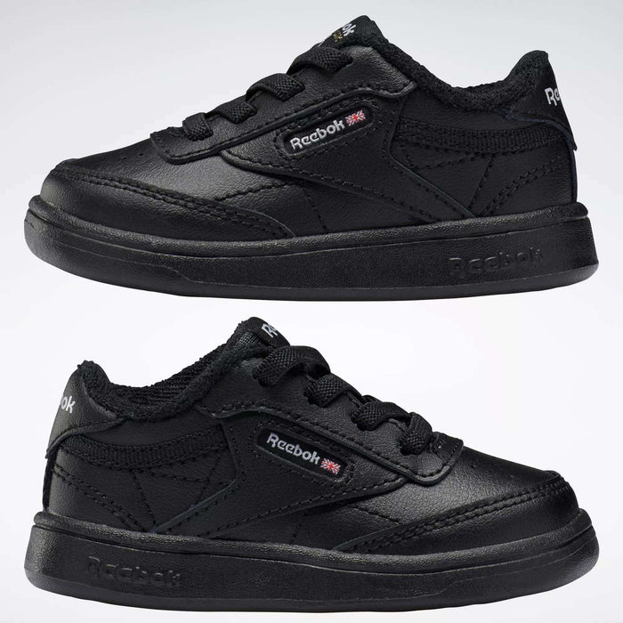 Two black Reebok Kids' Club C Shoes for babies and toddlers are displayed side by side on a white background, featuring soft leather uppers, textured soles, and visible logo details.