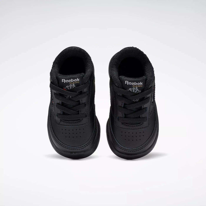 A pair of Reebok Kids' Club C Shoes for babies and toddlers, in black soft leather, are displayed side by side on a plain white background, viewed from above.