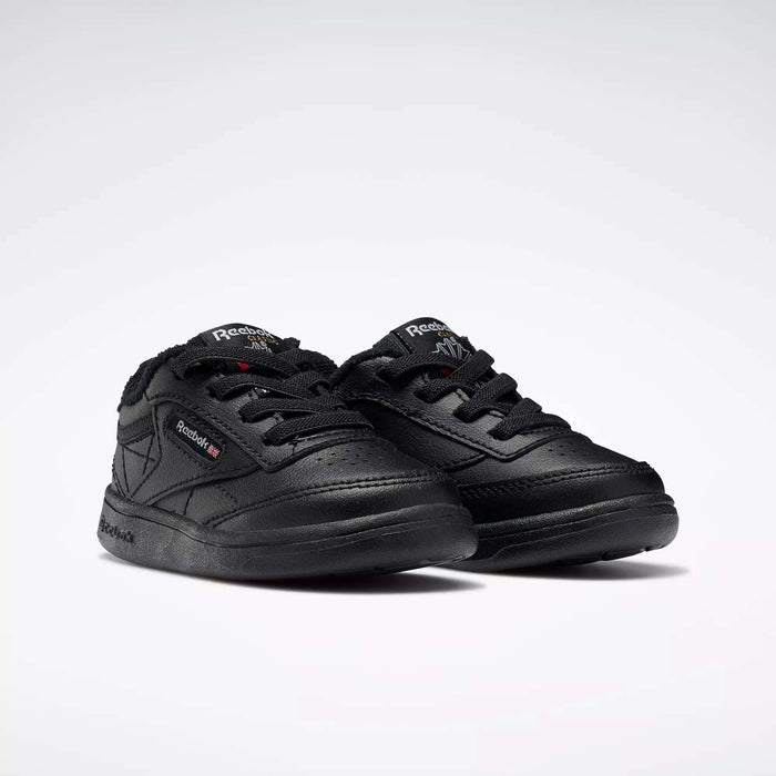 A pair of Reebok Kids' Club C Shoes for babies and toddlers, featuring a low-cut black leather design with laces and brand logos on the side and tongue, displayed on a plain white background.