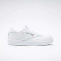 The Kids' Club C Shoes – Grade School by Reebok are white low-top sneakers with soft leather uppers, the Reebok logo, and a small Union Jack flag on the side, shown on a plain white background.