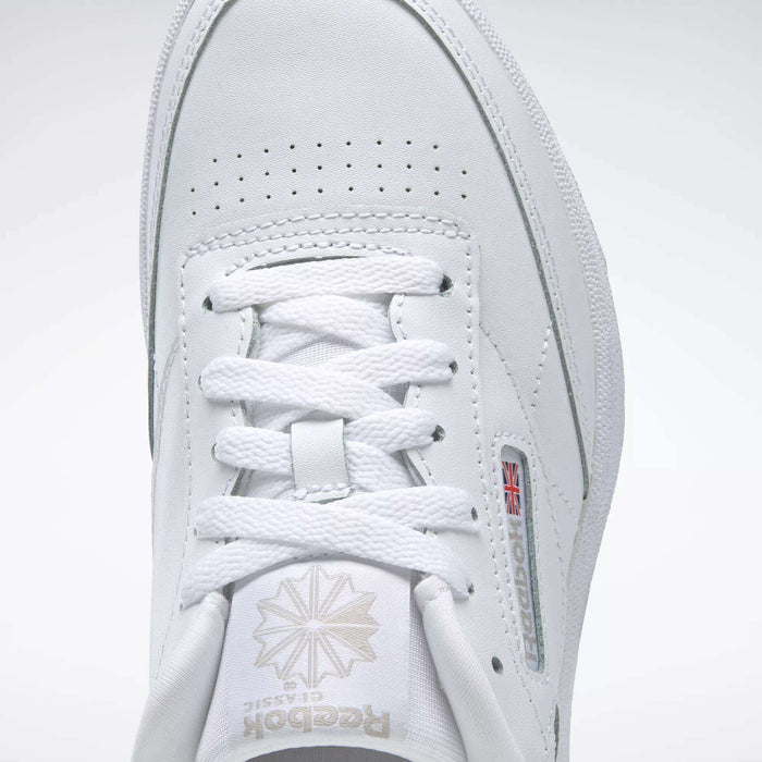 Close-up of the Reebok Kids' Club C Shoes - Grade School, showcasing the top view with laces, Reebok logo with Union Jack side detail, and soft leather uppers for timeless comfort.