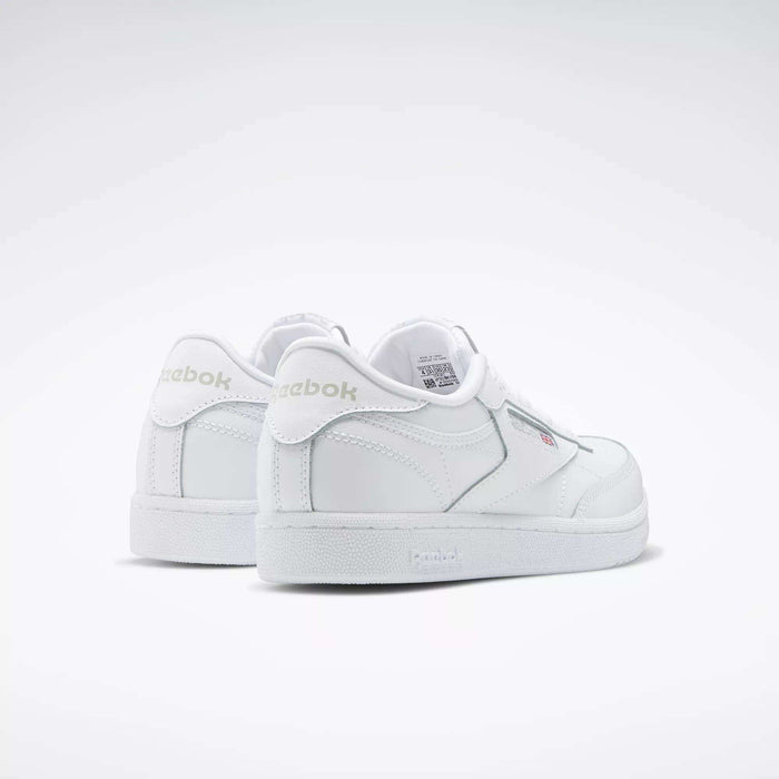 A pair of Reebok Kids' Club C Shoes - Grade School is displayed on a plain white background, featuring soft leather uppers, a low-cut silhouette, subtle stitching details, and visible Reebok branding on the side and heel.