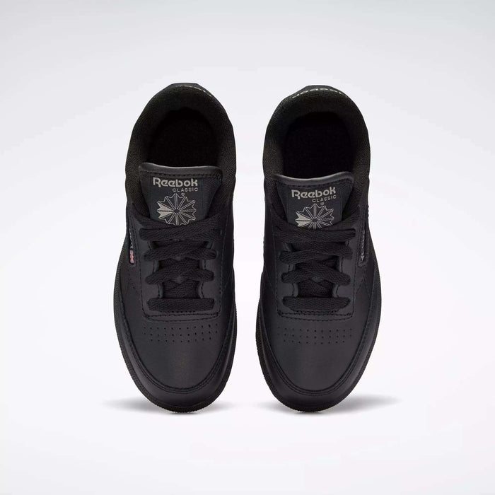 Top view of Kids' Club C Shoes by Reebok: classic black sneakers featuring a durable leather upper, black laces, perforated toe details, and Reebok logos on each tongue.