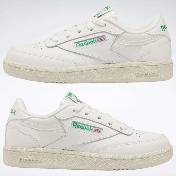 Two white Reebok Kids' Club C Shoes - Preschool, shown from the side with green and red logo details and an off-white sole, bring timeless '80s style for everyday wear.