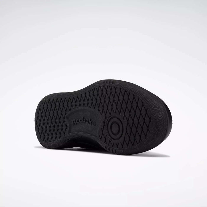 The image shows the black rubber sole of Reebok Kids' Club C Shoes - Little Kids, viewed from the bottom. The sole has a diamond tread pattern with the Reebok logo and branding in the center.