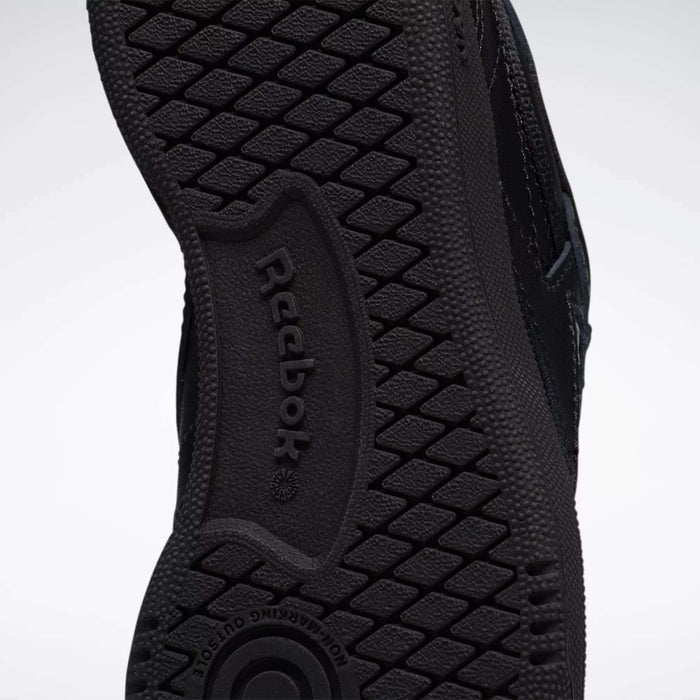 Close-up of the black rubber sole on Reebok Kids' Club C Shoes - Little Kids, featuring the Reebok logo and a textured tread pattern for grip—perfect for durable playground sneakers.