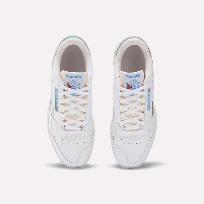 Top view of Reebok Defiance 88 Shoes in white leather with beige soles, light tan laces, blue Reebok branding, and a blue and pink tongue graphic, finished with subtle metallic details for a stylish look.