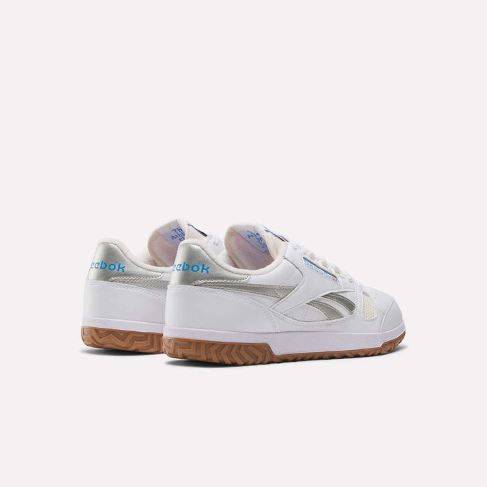 A pair of Reebok Defiance 88 Shoes in white with gum soles, metallic accents, and blue Reebok branding on the heel, shown on a plain white background.