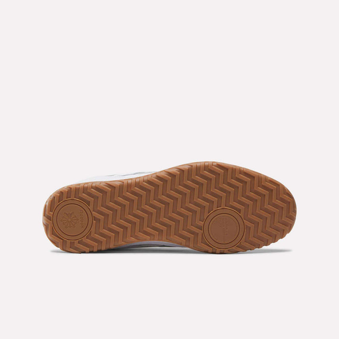The Reebok Defiance 88 Shoes feature a brown rubber sole with a herringbone tread, subtle branding, circular accents, and metallic details, shown from the bottom against a plain light background.