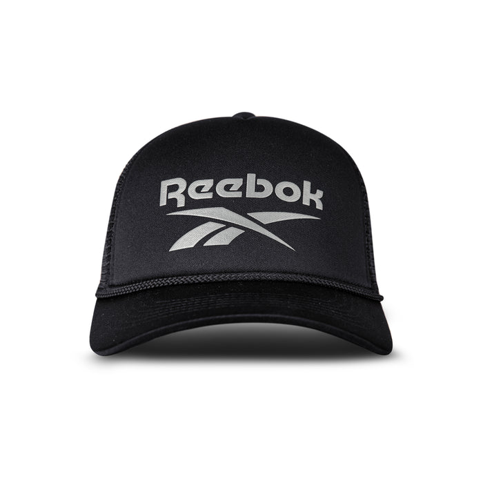 A black Reebok Deluxe Aero Cap is shown from the front with the white Reebok logo on the front panel, a curved brim, mesh sides, and an adjustable snapback closure.