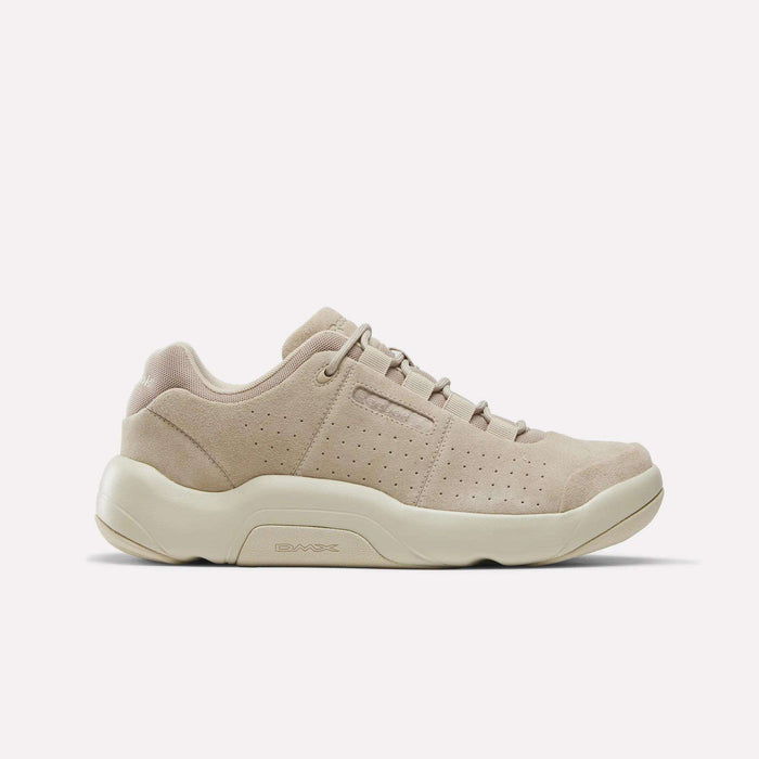 The Reebok DMX Comfort+ Classic walking shoe in Elevated Beige/Elevated Beige/Linen features perforated side panels, a round toe, and a chunky off-white sole with dynamic air cushioning for enhanced comfort, displayed in a side profile against a plain white background.