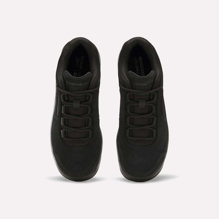 A pair of Reebok DMX Comfort+ Classic sneakers in black premium leather are viewed from above, displaying their laces and tongue against a plain white background.