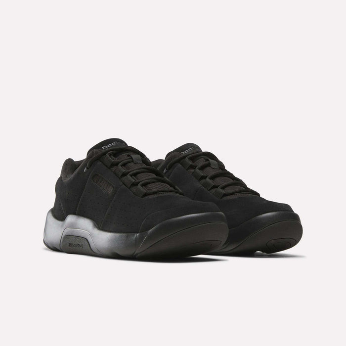 A pair of Reebok DMX Comfort+ Classic sneakers with thick, gradient black-to-gray soles and dynamic air cushioning are displayed side by side on a plain white background.