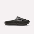 The Reebok DMX Recovery Mules are black slip-on shoes made from molded EVA, with cutout vents on the upper, a closed toe, and a chunky sole. Shown in side profile against a plain white background.