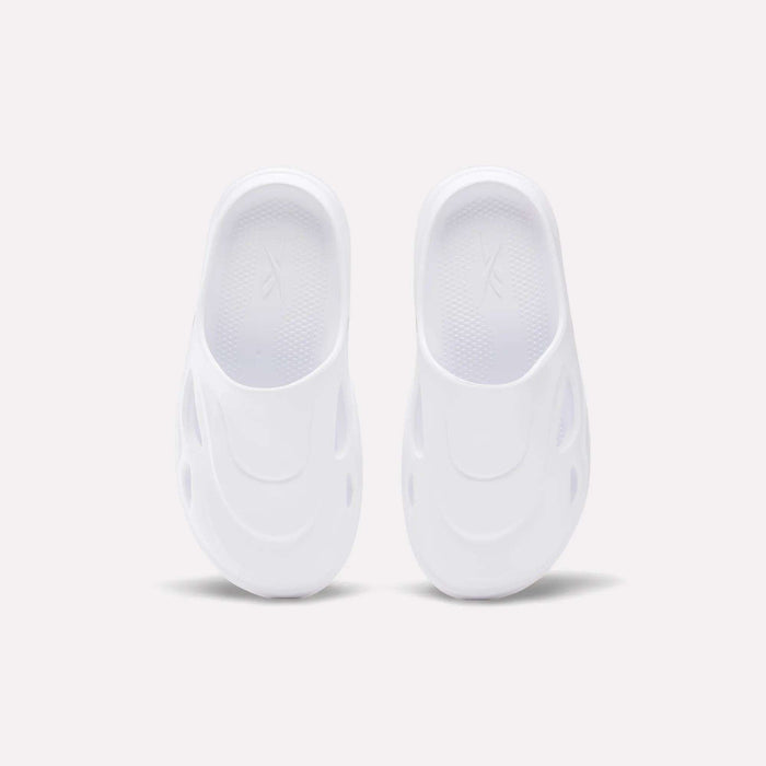 The Reebok DMX Recovery Mules are white slip-on shoes featuring a futuristic design with oval side cutouts, crafted from molded EVA, shown from above on a plain light background.