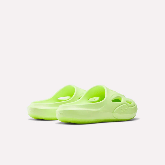The Reebok DMX Recovery Mules are neon green molded EVA slip-on clogs with cut-out holes and textured soles, shown from the back and side on a plain white background.
