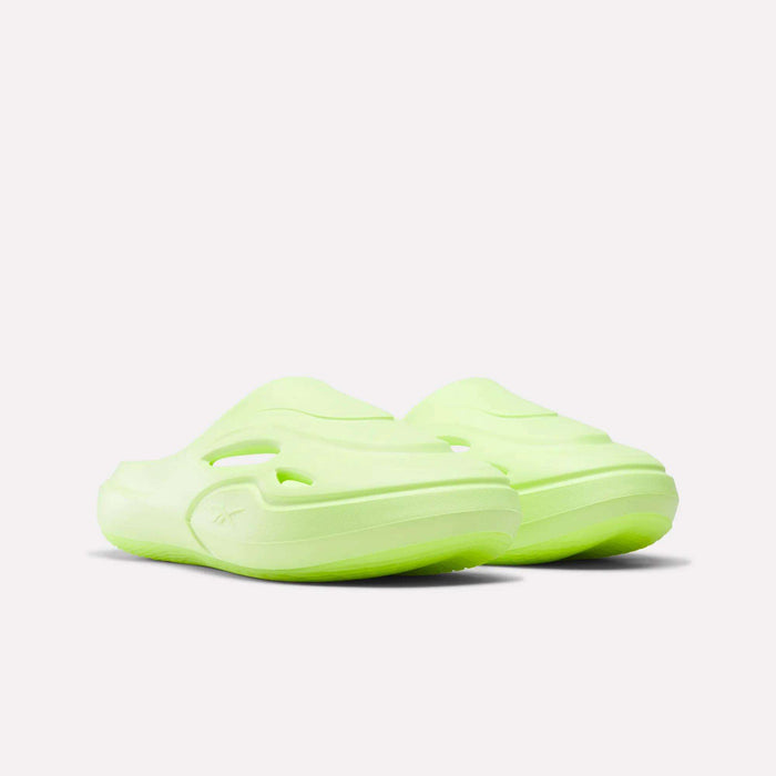 The Reebok DMX Recovery Mules are green slippers made from molded EVA, blending classic mule inspiration with comfort and style.