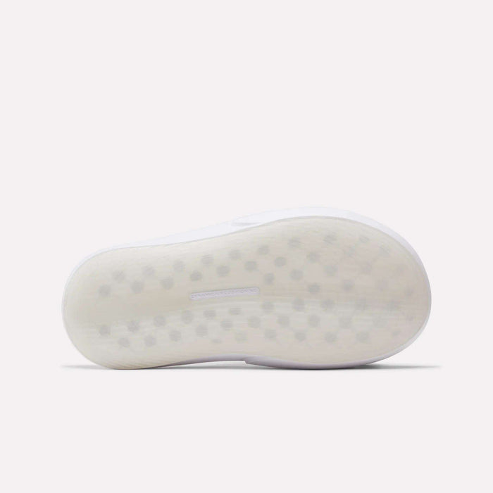 The image shows the sole of a white Reebok DMX Recovery Mule, featuring a lightly textured surface with small, evenly spaced hexagonal shapes. The background is plain and light-colored.