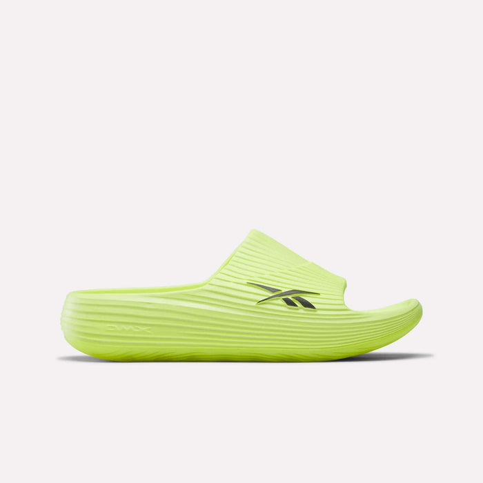 The Reebok DMX Recovery Walking Slides feature a bright yellow-green color, ribbed texture, open toe, black side logo, and moving air cushioning for comfort, shown against a plain white background.