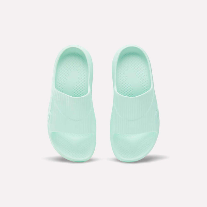 A pair of mint green Reebok DMX Recovery Walking Slides, made with super-soft foam, shown from above on a plain white background.