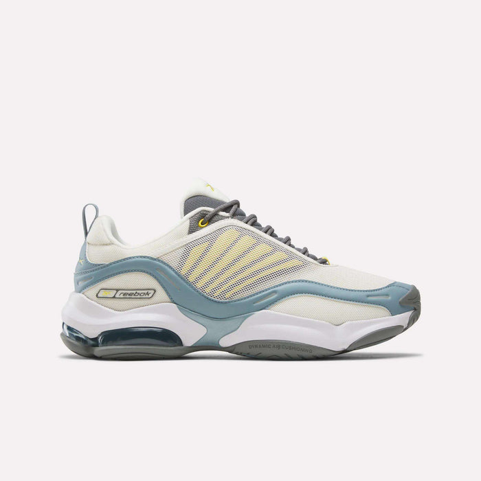 The Reebok DMX Series 3000 Shoes feature a white base with grey and yellow accents, gray laces, and a visible air-cushioned sole for comfort. Shown in White/Grey/Yellow against a plain white background.