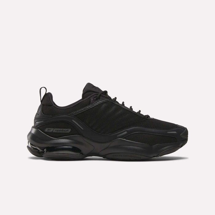 The Reebok DMX Series 3000 Shoes in black have a chunky sole, mesh and synthetic overlays, lace-up closure, and DMX moving air tech for comfort, shown in side view against a plain white background.
