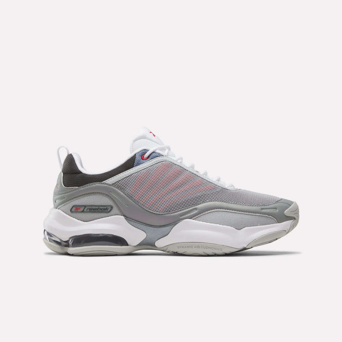 The Reebok DMX Series 3000 Shoes in Grey/White/Red feature mesh panels, white laces, a visible air-cushioned sole with DMX moving air technology for enhanced comfort, and subtle red accents. They are displayed on a plain white background.