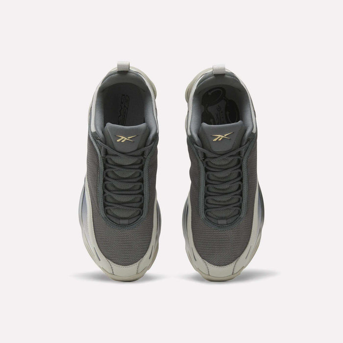 Top view of Reebok DMX Series 3000 Shoes in gray, with white soles, mesh uppers, and a gold logo on the tongues. Features DMX moving air technology for comfort. Displayed on a plain white background.